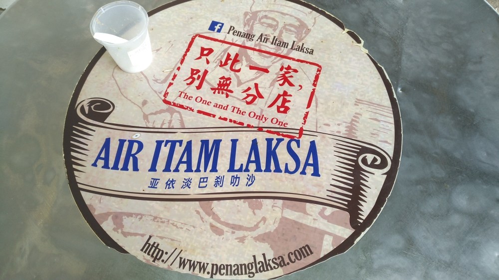 Air Itam Laksa sticker logo on your table, with a plastic cup of salt if need to flavour your laksa